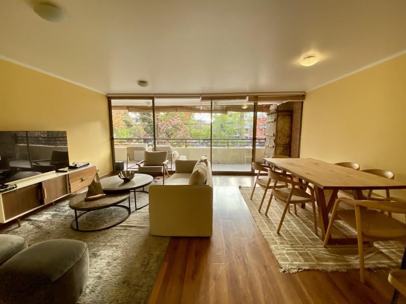 Vista del living comedor desde el acceso, con la mesa de comedor junto al ventanal.